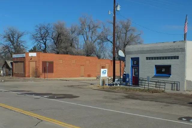 Brick and block buildings on a quiet Agate street corner under bare cottonwoods