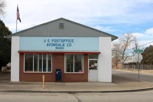 Avondale's small brick post office on a quiet corner with cottonwoods behind