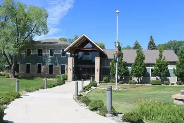 Bayfield town hall with lawn and tall trees on a sunny day