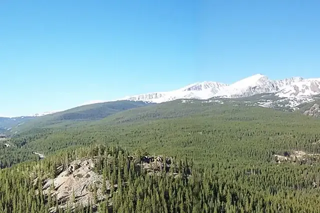 Snow-capped peaks of the Tenmile Range above forested slopes near Breckenridge
