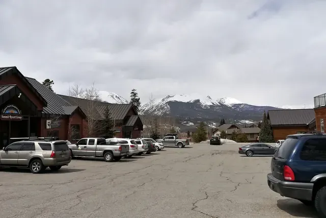 Mountain-style buildings in Dillon with snowy peaks in the distance