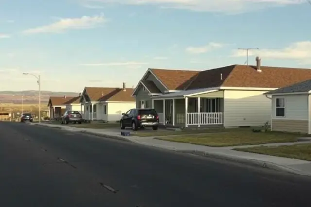 Modest ranch homes on a flat street in Evans