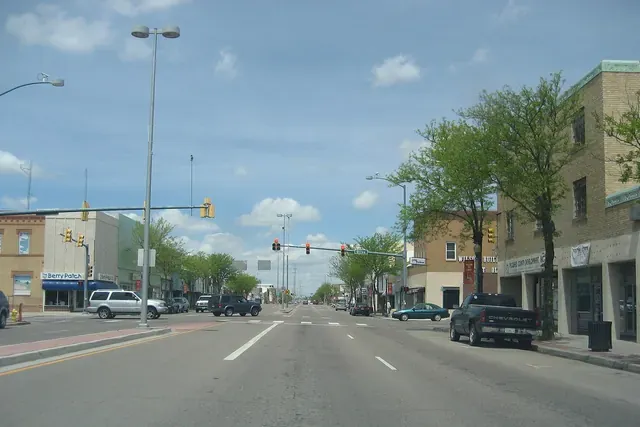Main Street in Lamar with brick buildings and trees on a clear day