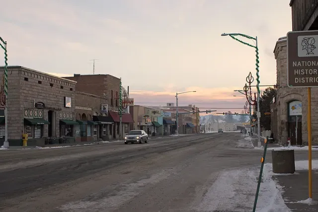 Historic brick storefronts in downtown Monte Vista at dusk