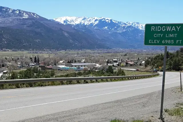Ridgway seen from Highway 62 with the snowy San Juan Mountains behind the town