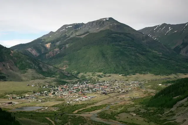 Silverton's grid of houses in the Animas River valley below green San Juan peaks
